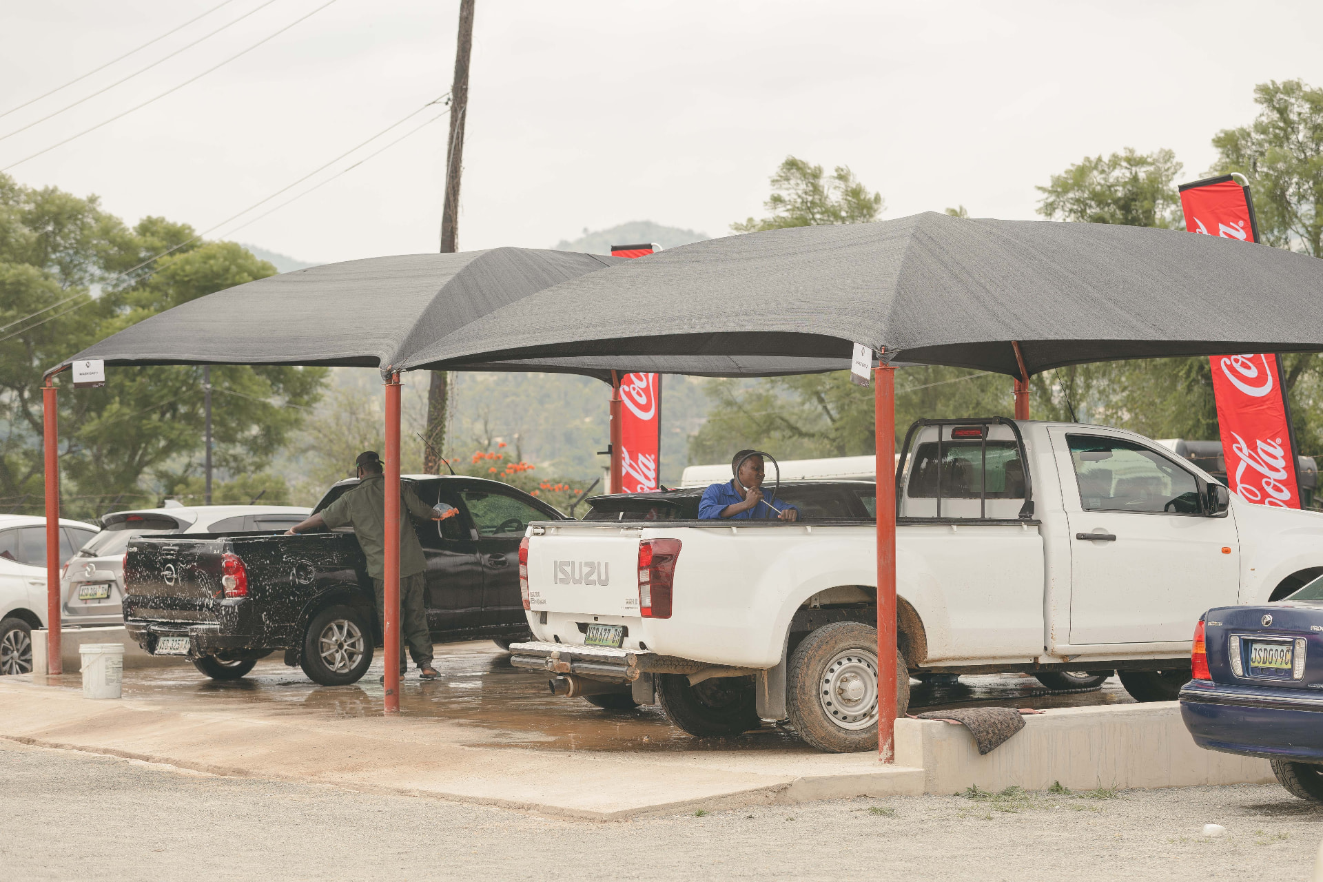 Shaded wash bays with cars being cleaned at MAPS Village Lifestyle in Manzini